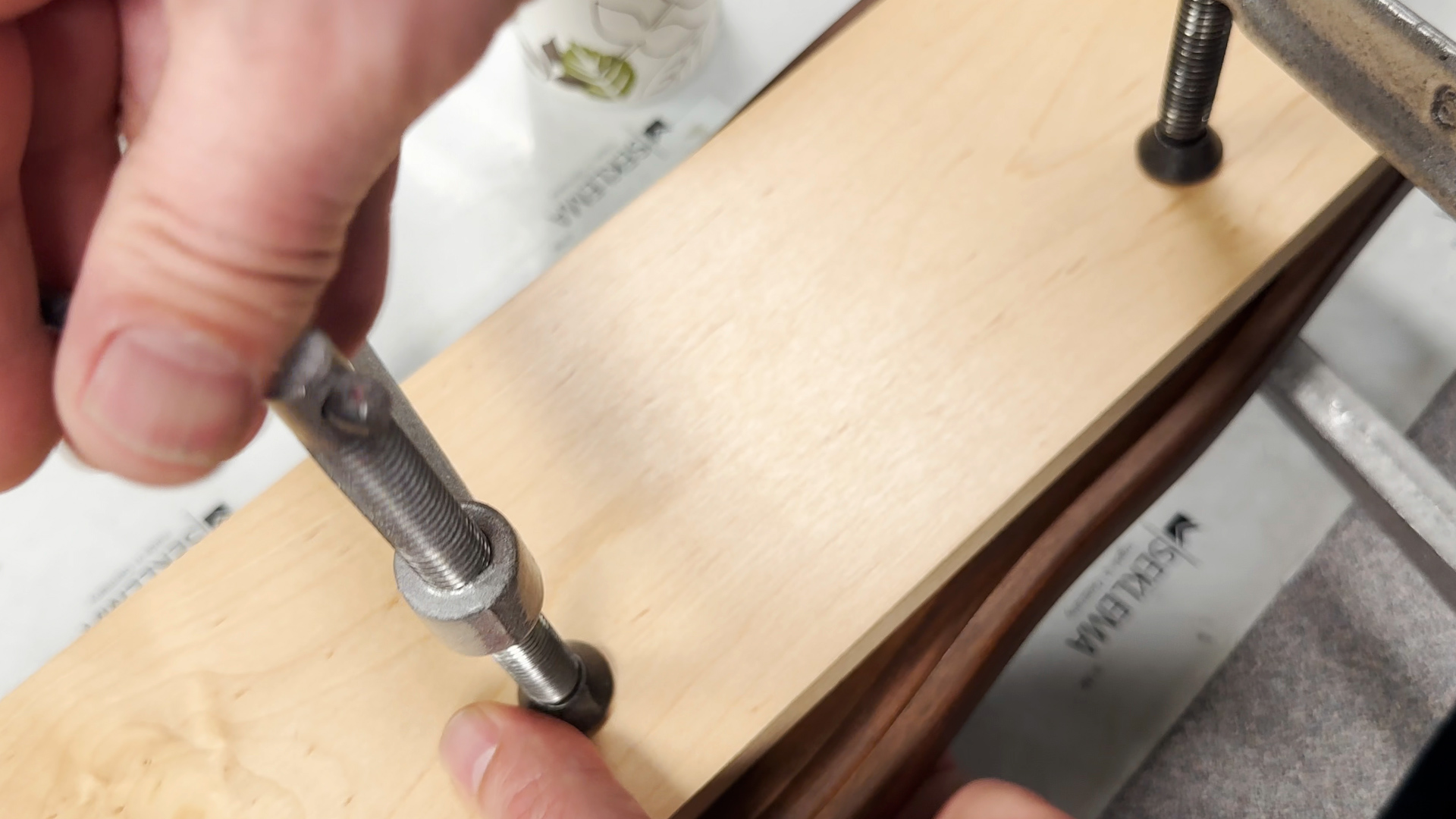 Clamp a piece of wood to cutting board until dry